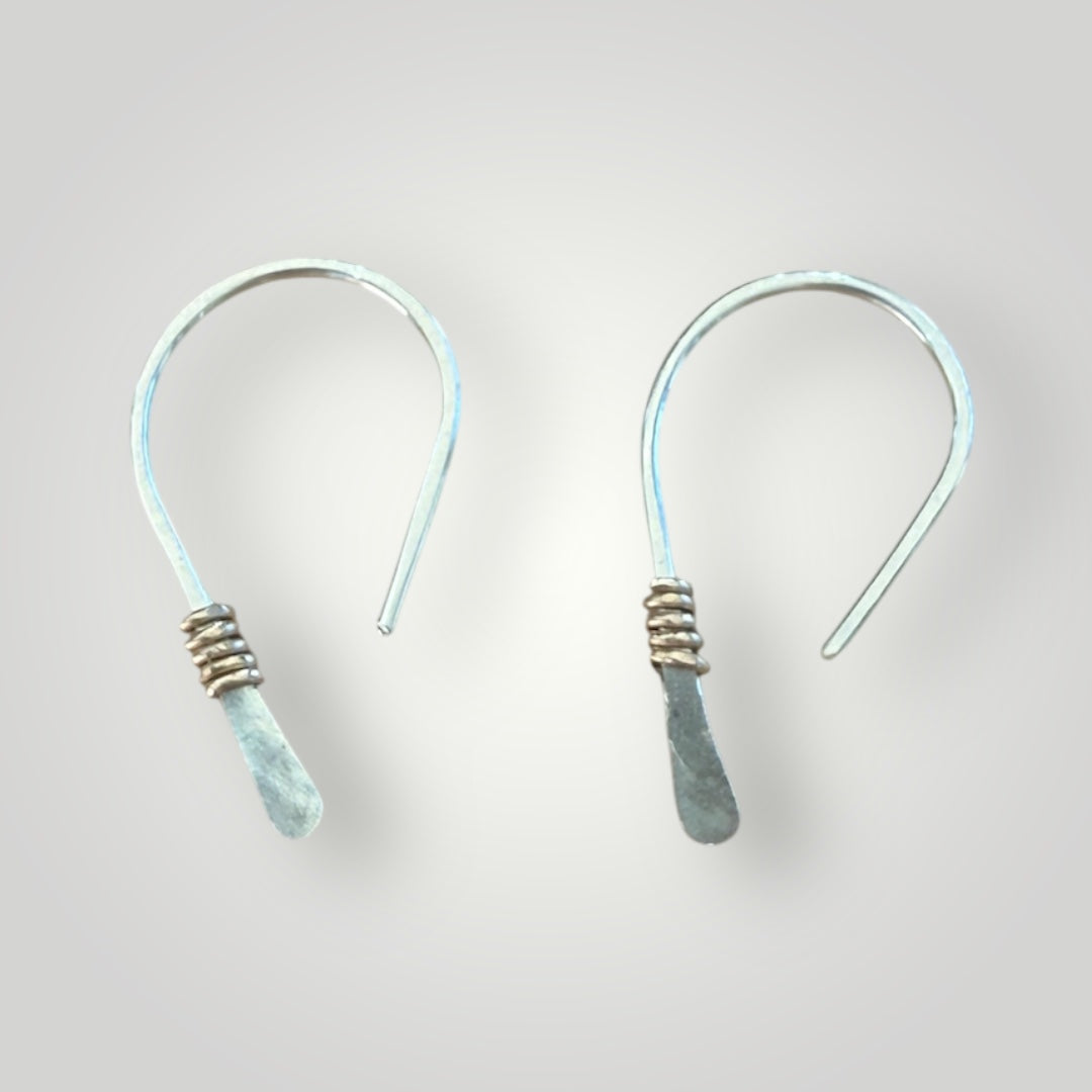 Hammered half hoop huggie is gold accent