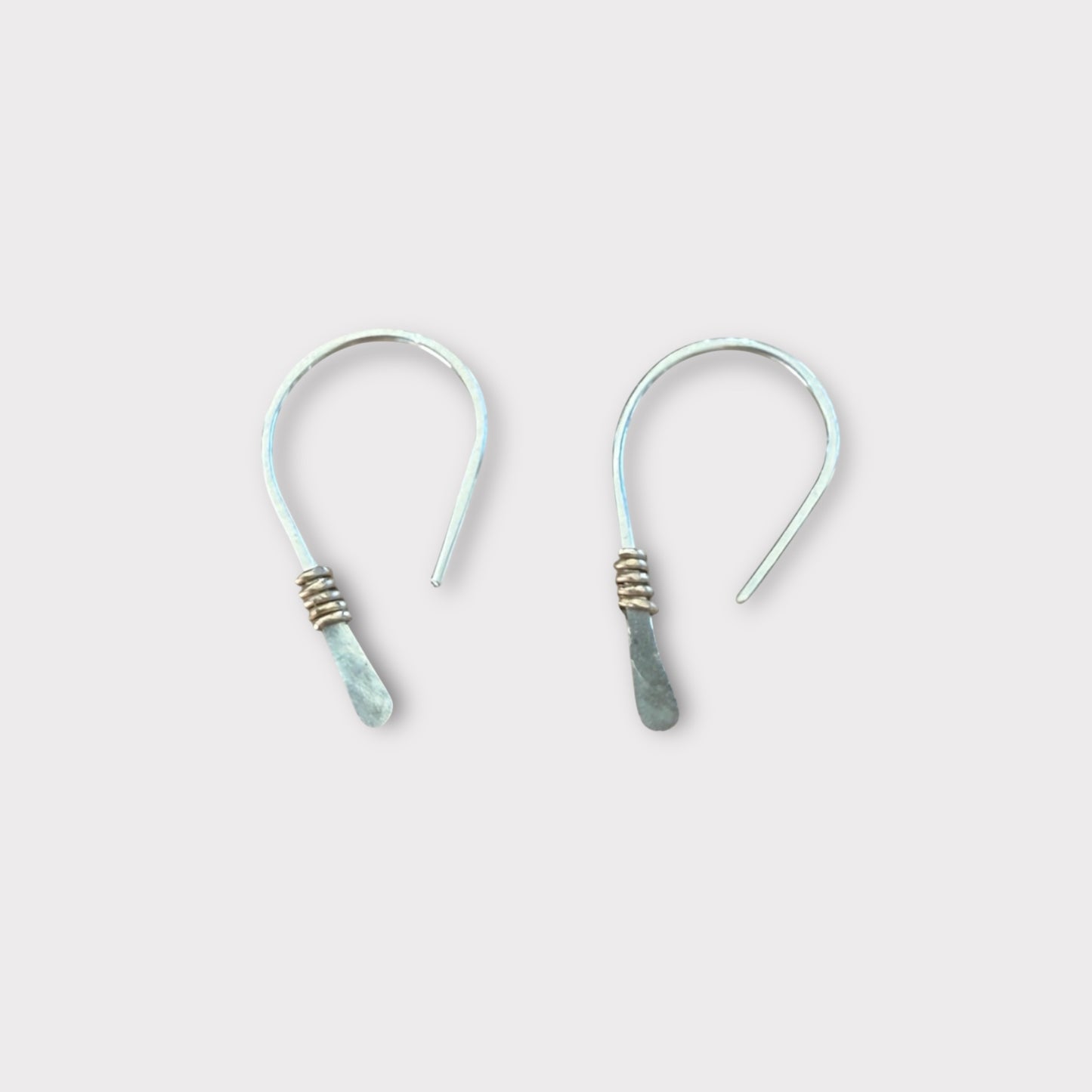 Hammered half hoop huggie is gold accent