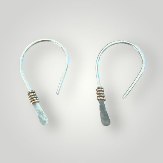 Hammered half hoop huggie is gold accent